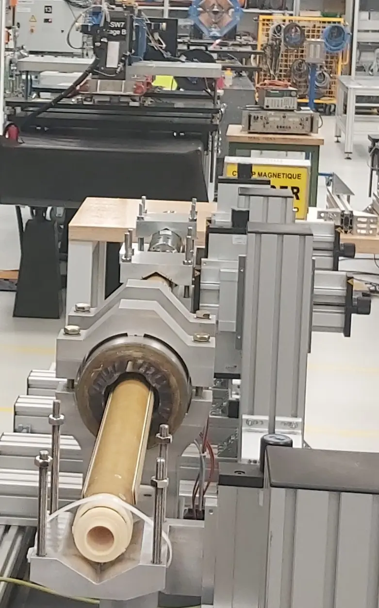Mechanical tooling around a coil in a CERN workshop